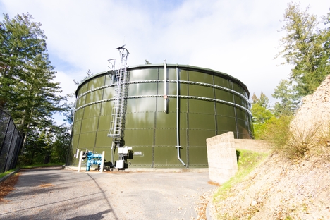 A large green water tank